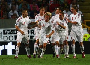 The Danes celebrating the win 3-2 in Portugal which put them leaders of Group one.